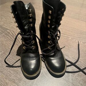 Stuart Weitzman black lace up boots with gold trim